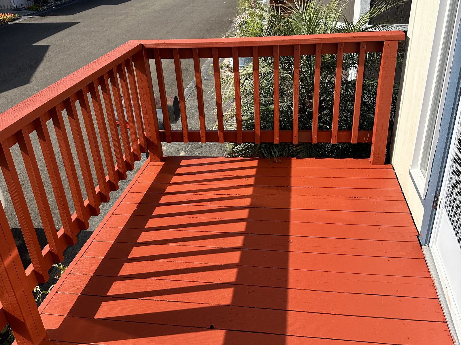 Freshly painted red railing and deck area completed by Big Iron
